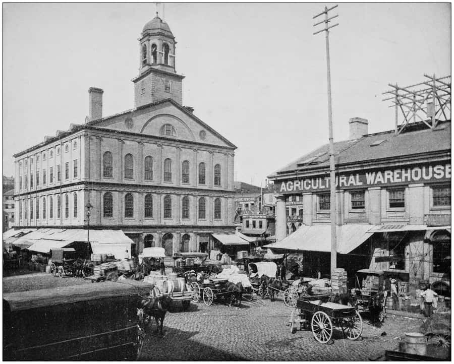 A historic photograph of the exterior of Faneuil Hall, in Boston.