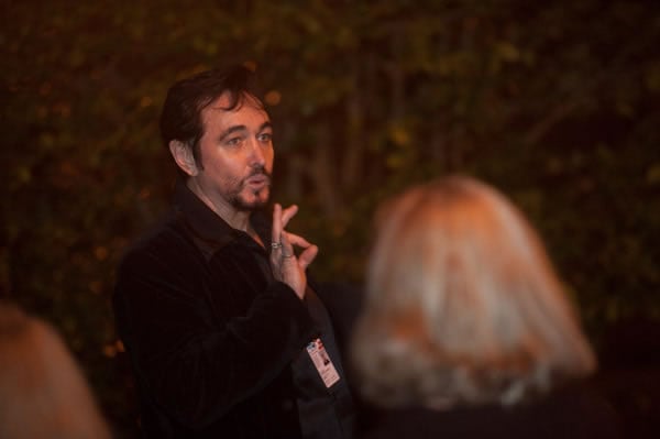 Nicodemus, one of our Ghost Tours guides, walking people around the historic district on a tour