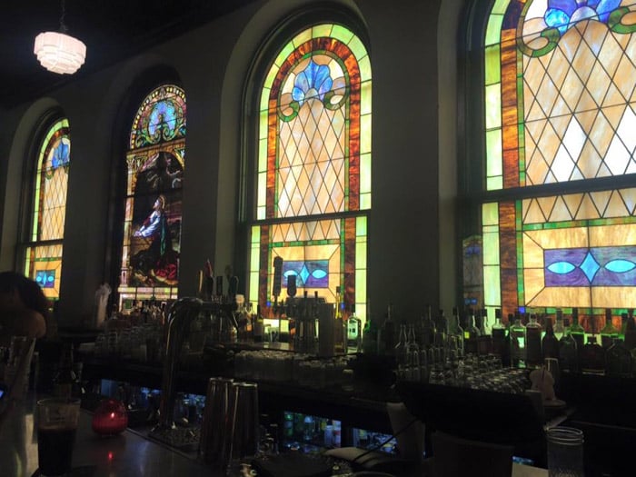 A photo of the stained glass windows behind the bar at the former Alamo Street Theater in San Antonio Texas